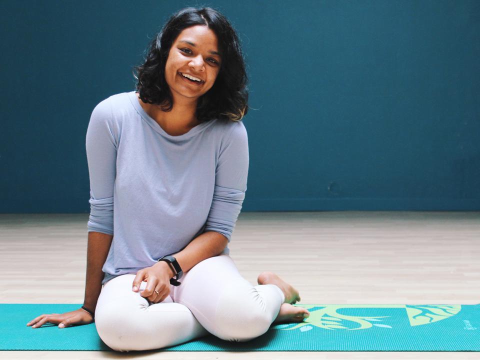 Amiti smiling on yoga mat